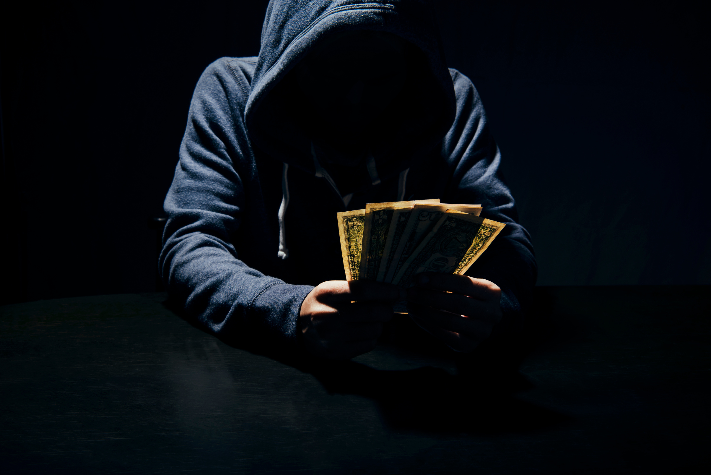 Businessman giving bribe banknote money corruption scam in dark. concept bribery for business.
